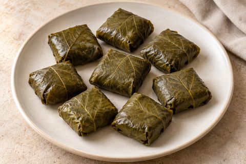 AI illustration of small square parcels folded from cooked grape leaves.