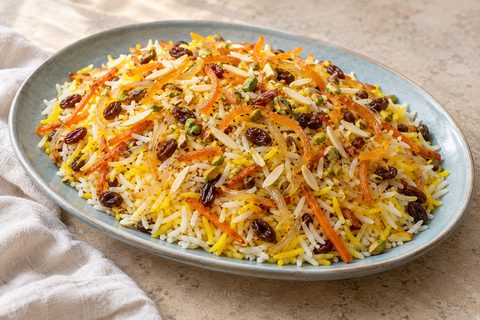 AI illustration of Persian sweet rice with candied citrus peel, carrot strips, raisins, almonds and pistachios.